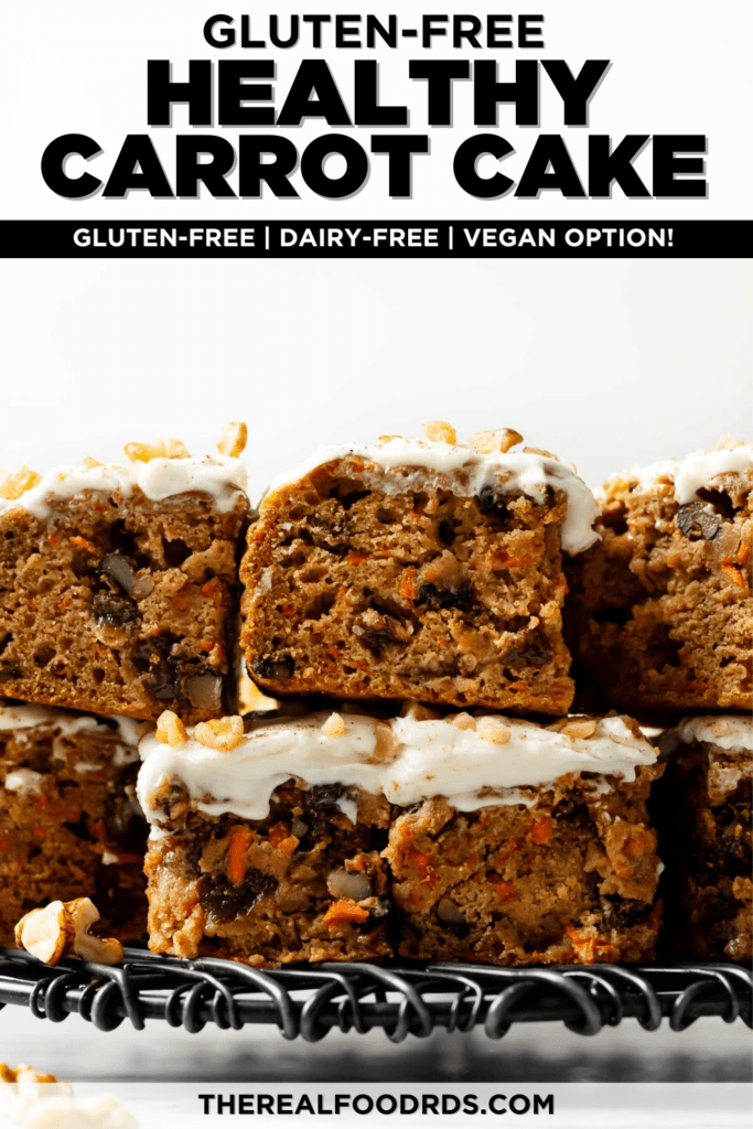 Carrot cake bars frosted with cream cheese frosting cut into bars and stacked on top each other